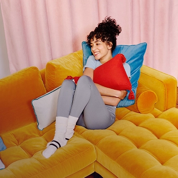 Cliente détendue à domicile bénéficiant d’un service de collecte et livraison pressing à domicile Lyon